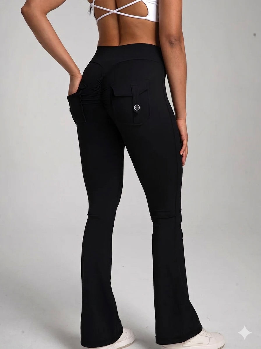 Black flared workout pants with back pockets, worn with white sports bra and sneakers