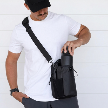 Man in white tee with black crossbody gym bag holding water bottle, fitness lifestyle gear